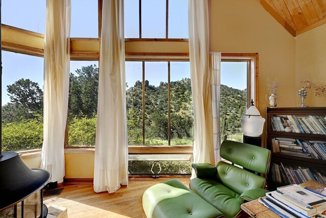 sunroom featuring wooden ceiling and lofted ceiling