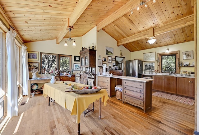 dining room with wood ceiling, beam ceiling, high vaulted ceiling, a chandelier, and light hardwood / wood-style floors