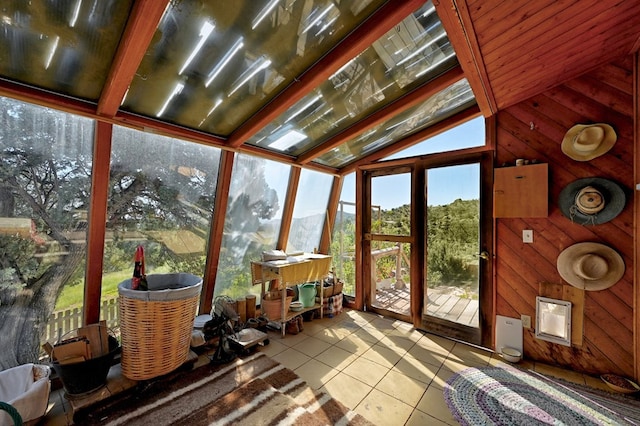 unfurnished sunroom with lofted ceiling