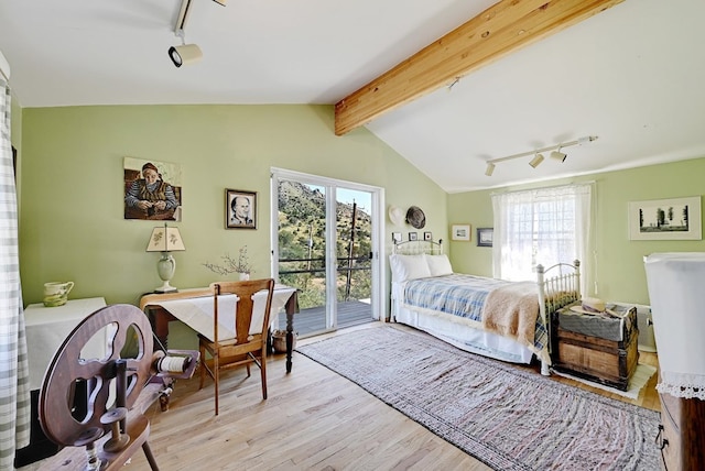 bedroom with access to exterior, light wood-type flooring, lofted ceiling with beams, and track lighting