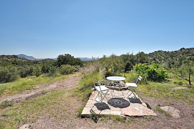 view of yard with a mountain view and a patio area