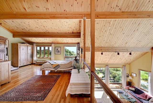 living room featuring vaulted ceiling with beams, light wood-type flooring, and wood ceiling