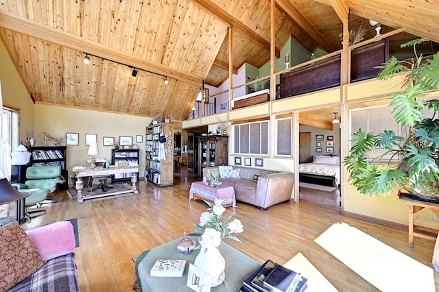 living room with beamed ceiling, hardwood / wood-style flooring, high vaulted ceiling, and wooden ceiling