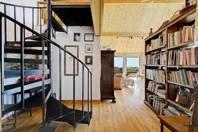 stairway featuring wood-type flooring, vaulted ceiling with beams, and wooden ceiling