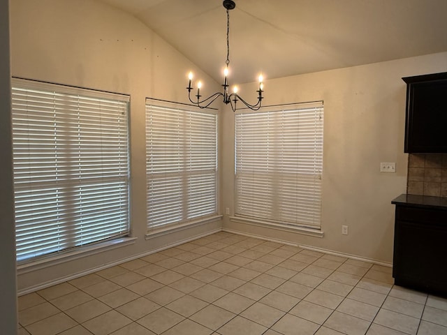 unfurnished dining area with light tile patterned flooring, lofted ceiling, and a chandelier