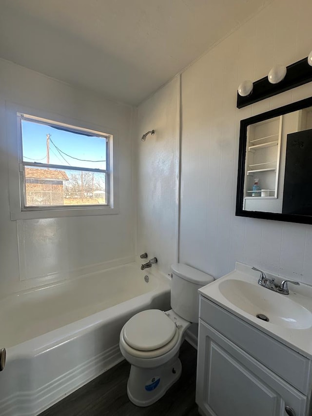 bathroom with toilet, bathtub / shower combination, wood finished floors, and vanity