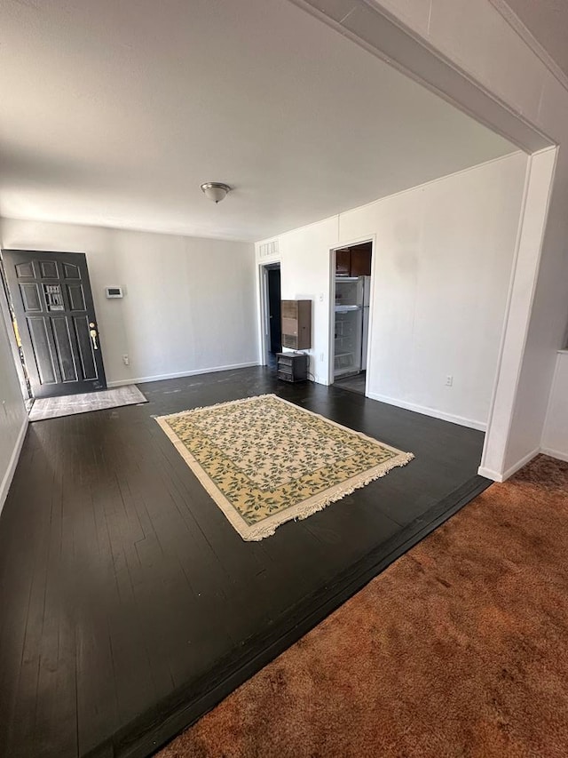 interior space with baseboards and dark wood finished floors