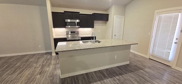 kitchen featuring a sink, dark wood-type flooring, appliances with stainless steel finishes, and dark cabinets