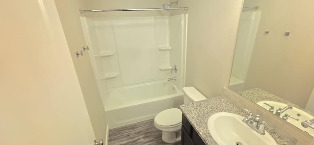 full bath featuring toilet, wood finished floors, and vanity