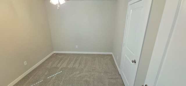 unfurnished room with carpet and baseboards