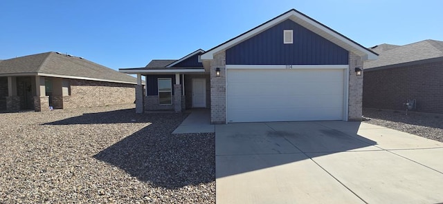 single story home featuring board and batten siding, concrete driveway, brick siding, and a garage