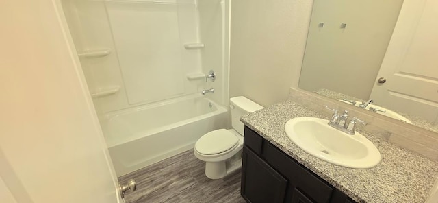 full bath featuring toilet, vanity, bathing tub / shower combination, and wood finished floors