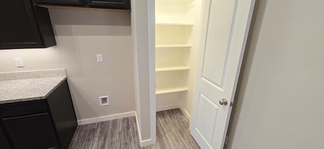 bathroom with baseboards, wood finished floors, and vanity