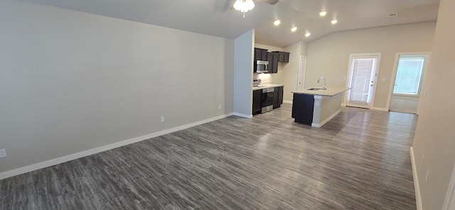 kitchen featuring dark wood-style floors, open floor plan, light countertops, and baseboards