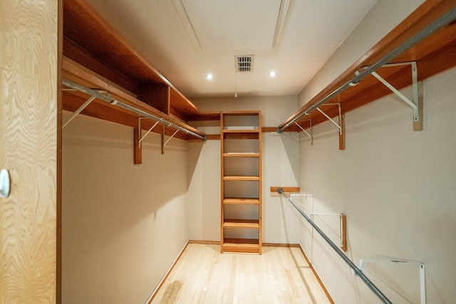 spacious closet featuring light hardwood / wood-style floors