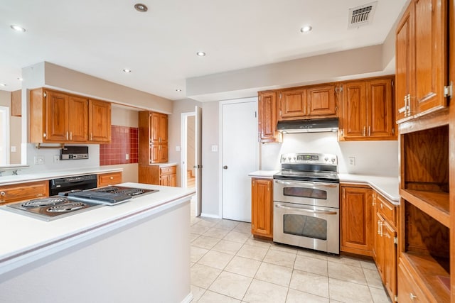 kitchen featuring range with two ovens, light tile patterned flooring, and dishwasher