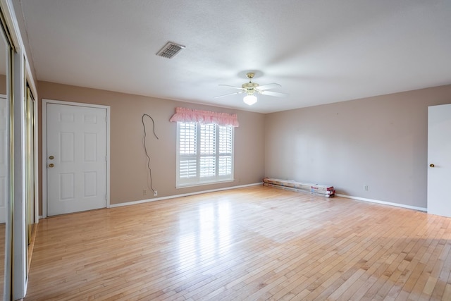 spare room featuring ceiling fan and light hardwood / wood-style flooring