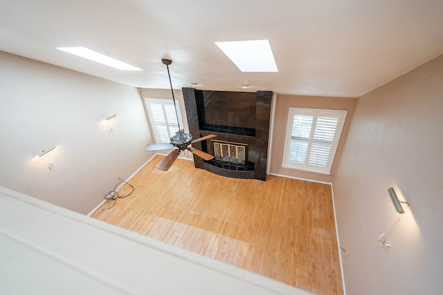 living room with a tile fireplace and a wealth of natural light