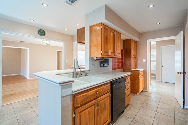 kitchen with sink, light tile patterned floors, dishwasher, decorative backsplash, and kitchen peninsula