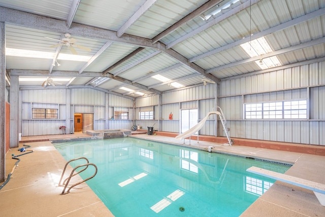 view of swimming pool featuring a water slide and a diving board