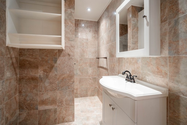 bathroom featuring tile walls and vanity