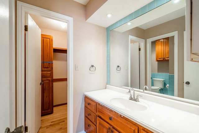 bathroom featuring vanity, hardwood / wood-style floors, and toilet