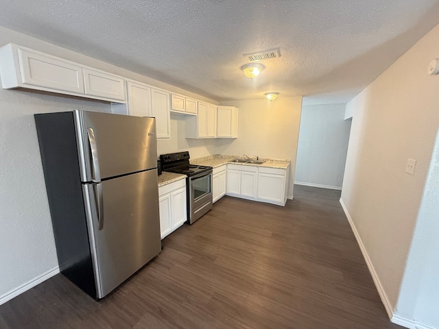 kitchen featuring sink, stainless steel refrigerator, dark hardwood / wood-style flooring, range with electric cooktop, and white cabinets