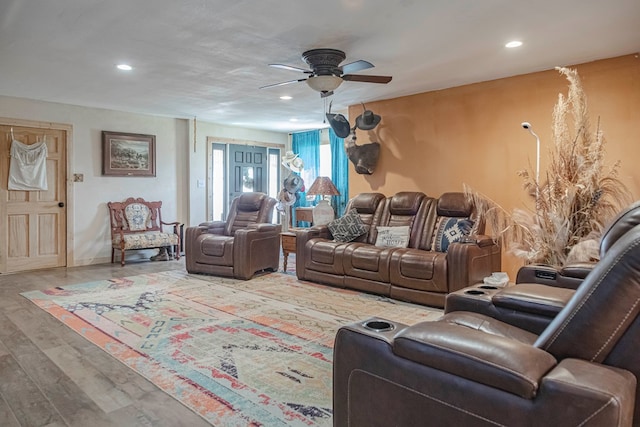 living room featuring ceiling fan and hardwood / wood-style floors