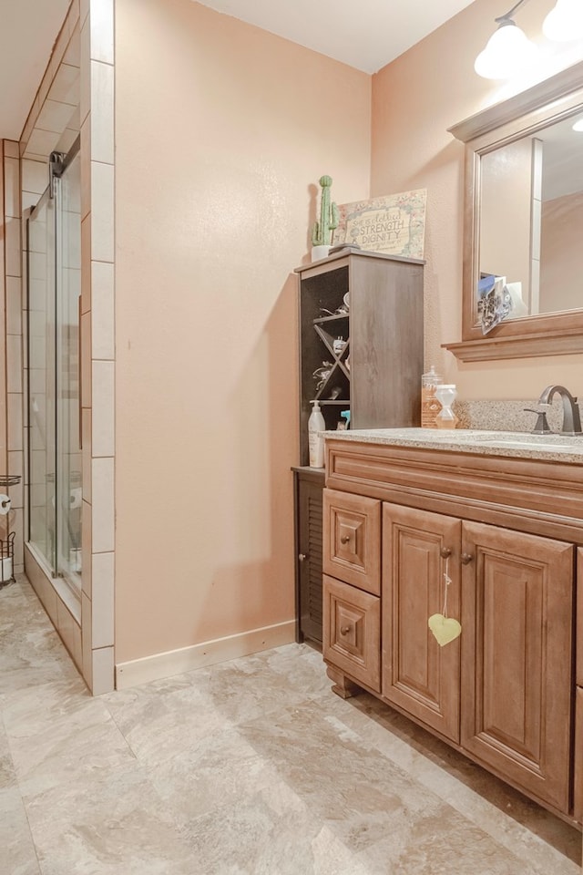 bathroom with vanity and a shower with shower door