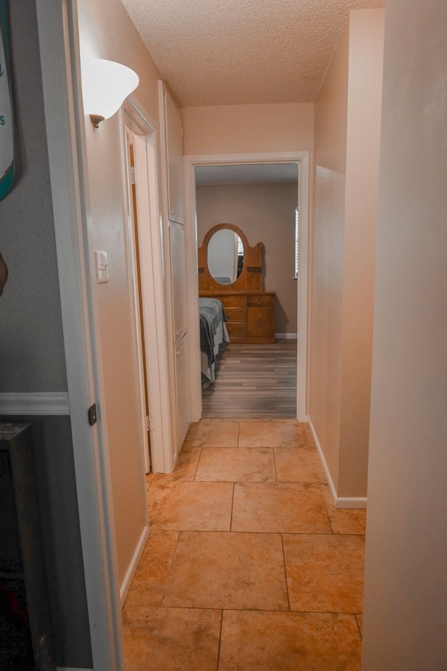 hallway featuring a textured ceiling