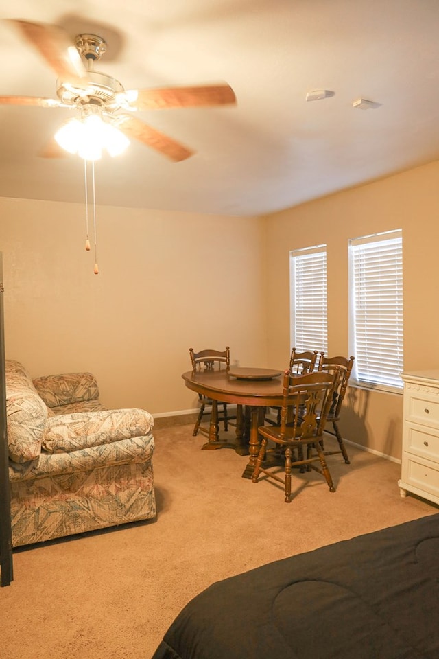 carpeted dining room featuring ceiling fan