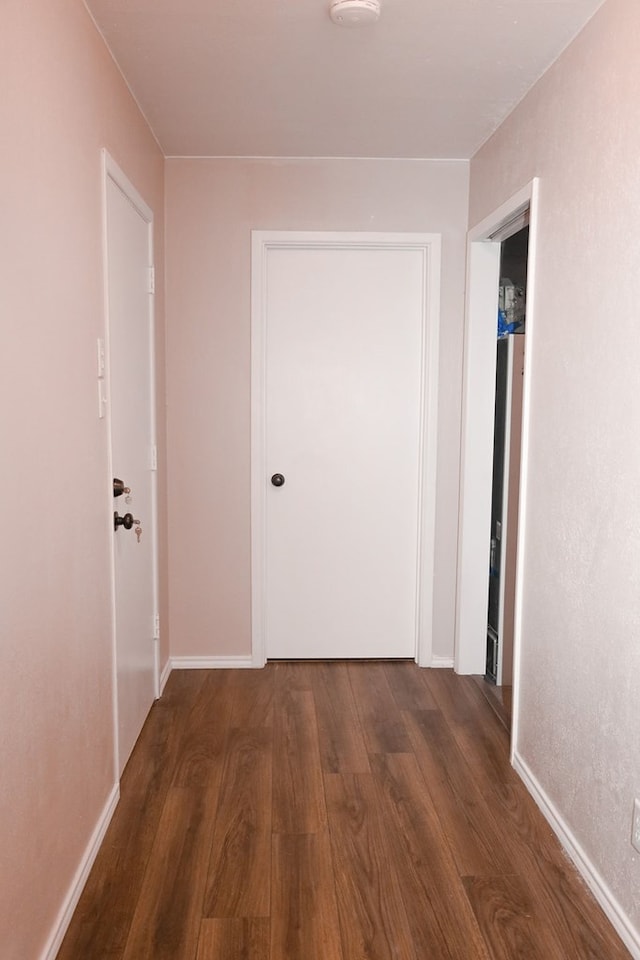 corridor with dark hardwood / wood-style floors