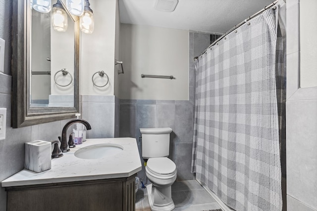 bathroom featuring tile walls, vanity, walk in shower, toilet, and a textured ceiling