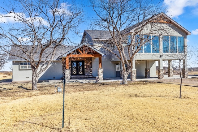 view of front of property with french doors and a patio area