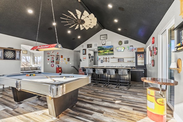 recreation room featuring hardwood / wood-style floors, billiards, high vaulted ceiling, and bar area