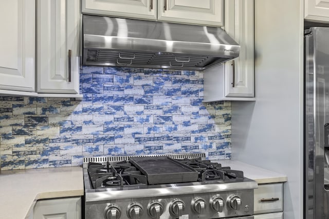 kitchen featuring tasteful backsplash, extractor fan, and appliances with stainless steel finishes