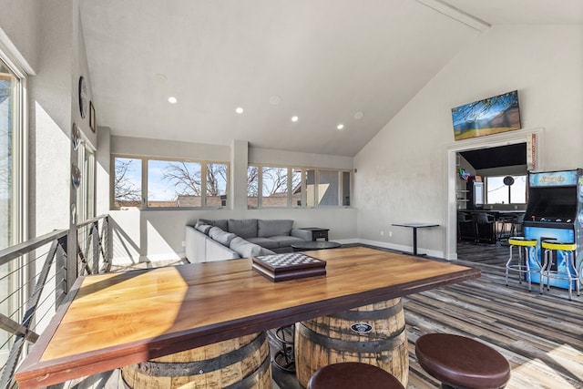 interior space with hardwood / wood-style flooring, beam ceiling, and high vaulted ceiling