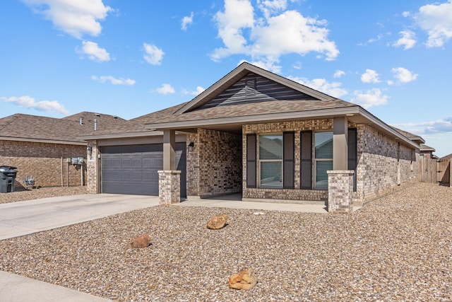 view of front of house featuring a garage, driveway, brick siding, and roof with shingles