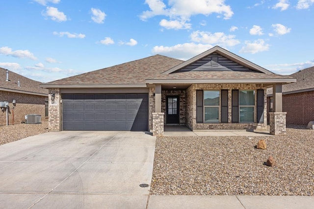 view of front of home with an attached garage, central AC, brick siding, driveway, and roof with shingles