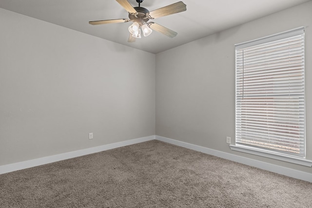 spare room featuring carpet floors, ceiling fan, and baseboards