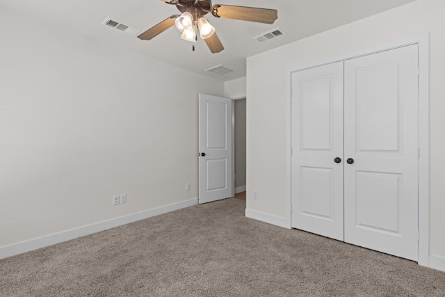 unfurnished bedroom with baseboards, carpet, visible vents, and a closet