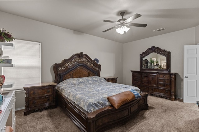 carpeted bedroom with ceiling fan and visible vents