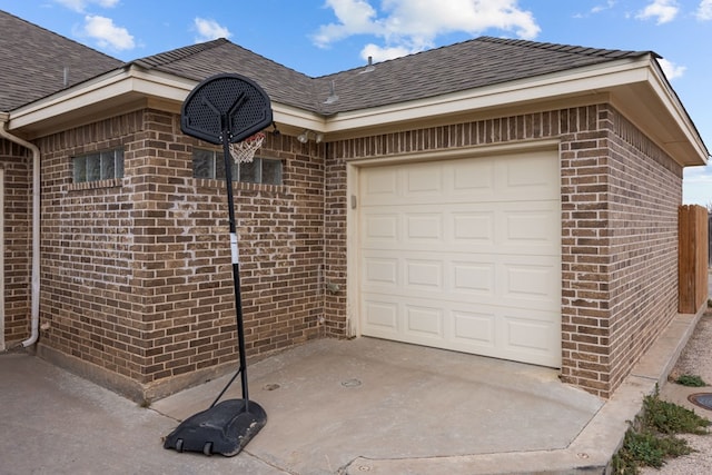 garage featuring concrete driveway