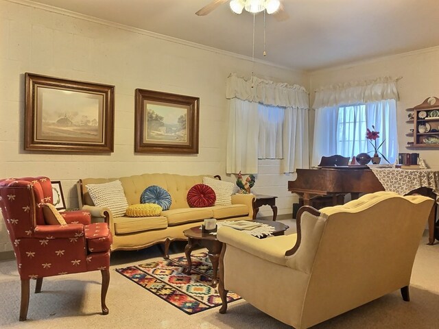 carpeted living room with ceiling fan and crown molding