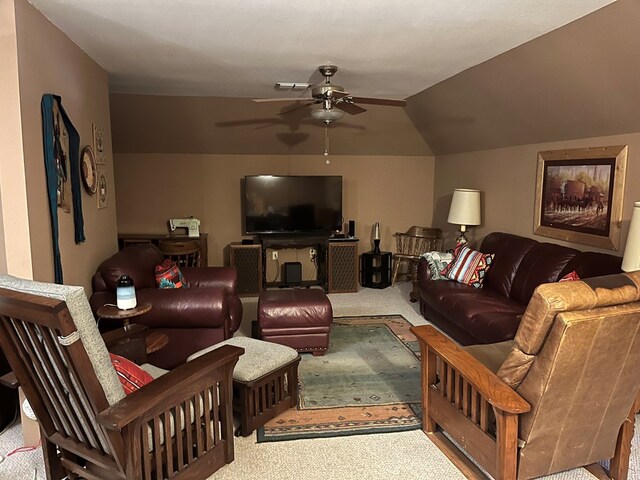 carpeted living room with ceiling fan and lofted ceiling