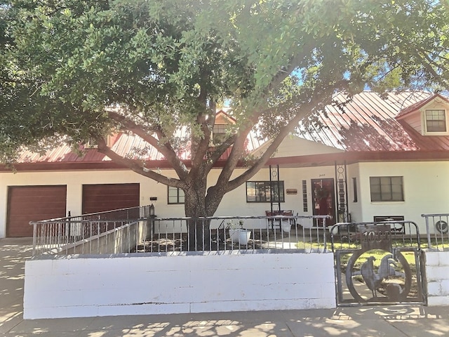 view of front facade with a porch and a garage