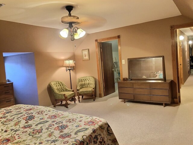 carpeted bedroom featuring ceiling fan and vaulted ceiling