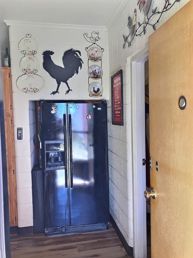 kitchen featuring dark hardwood / wood-style flooring, ornamental molding, and black refrigerator with ice dispenser