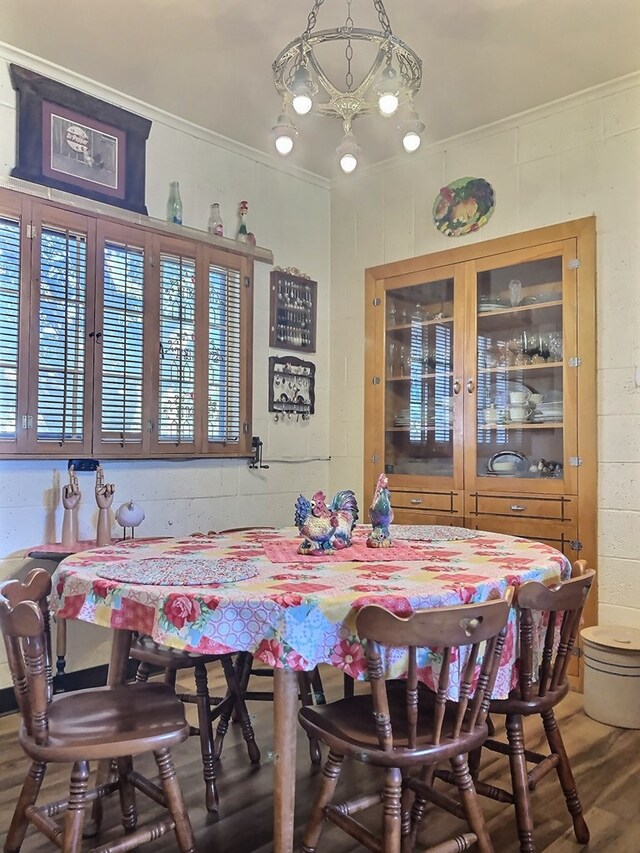 dining room with hardwood / wood-style floors and crown molding