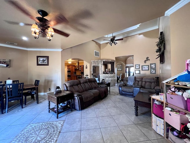 living area featuring arched walkways, visible vents, and light tile patterned flooring